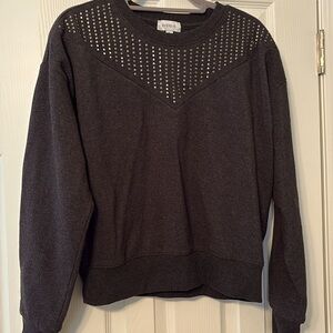 Sweatshirt with rivets along neck